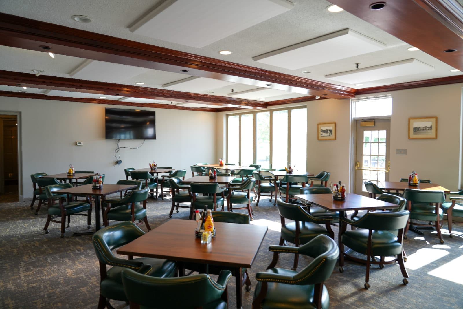 The clubhouse dining room, set for service in the afternoon light