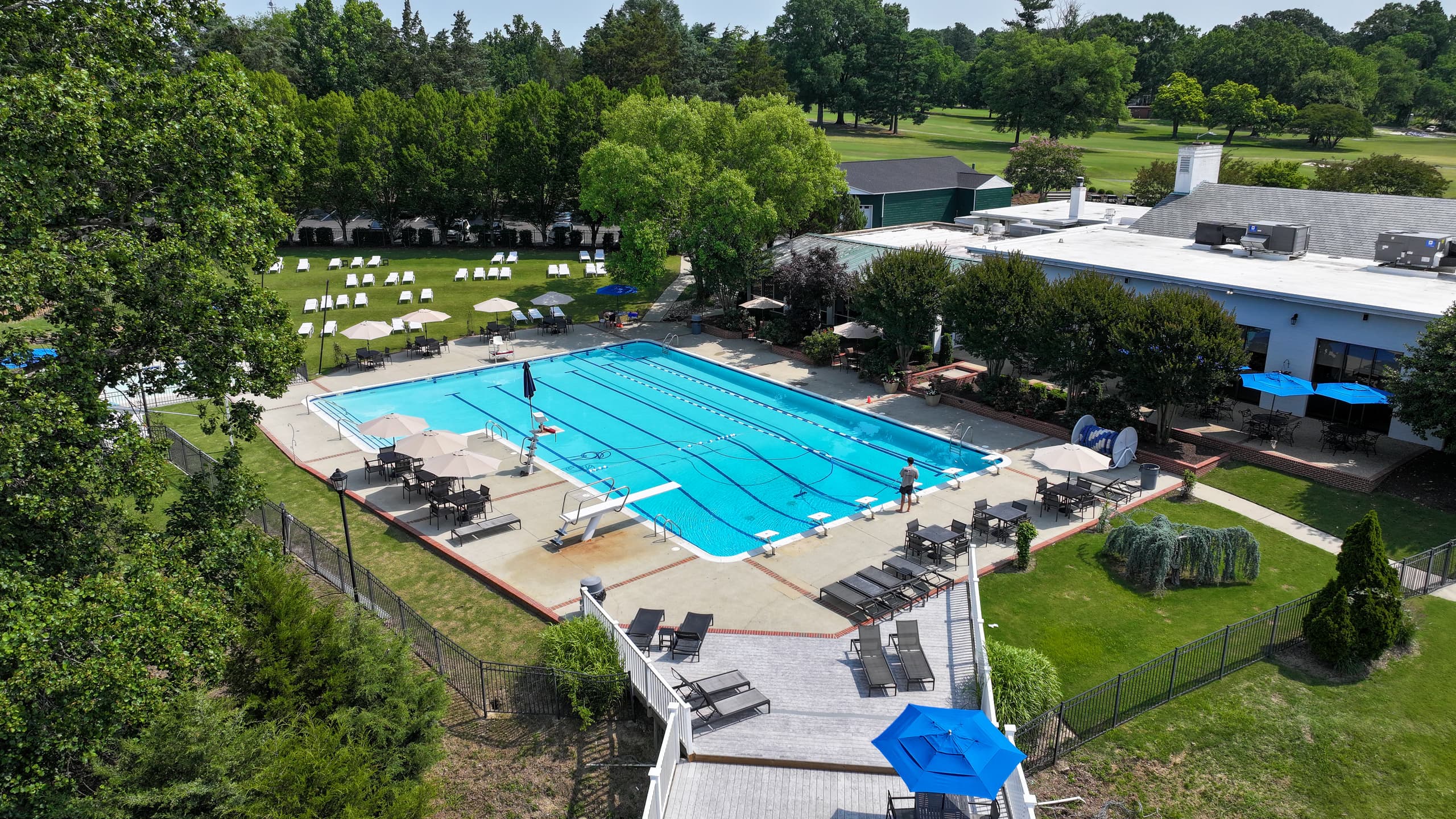The Lakeside Park Club pool and clubhouse from above, with the golf course beyond