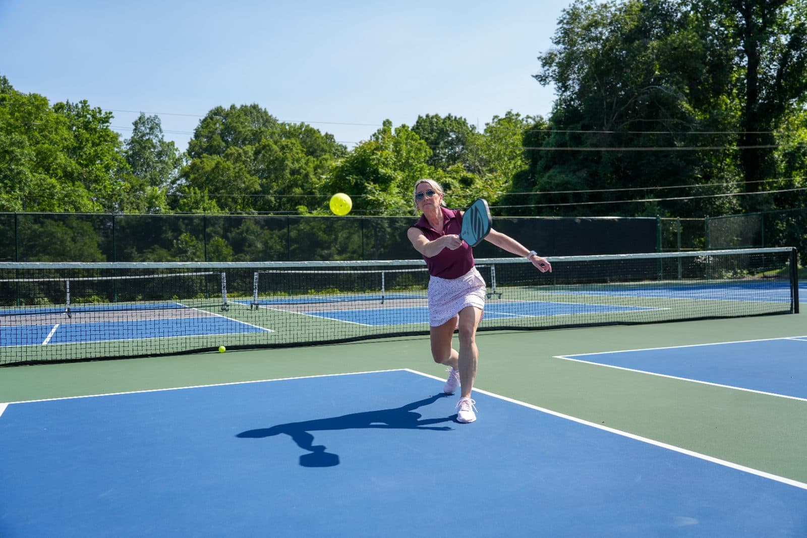 A member playing pickleball on the courts at the club